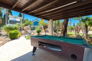 a pool table on a patio in front of a house at Villa Heaven in Protaras