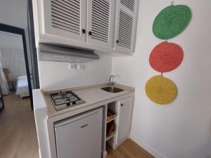 a kitchen with a sink and a stove top oven at Dar Zwina, Charming and lovely house in Tangier +8 photos