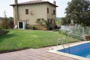 a house with a swimming pool in front of it at Mirador de San Marcos in Soria