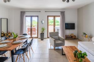 a living room with a table and a couch at Syra Bay in Megas Yialos-Nites