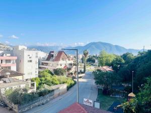 a city street with buildings and mountains in the background at Stylish&Luxury Flat with Garden Close to Sea in Finike