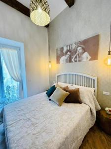 a bedroom with a large bed and a large window at Granoro Gragnano B&B in Gragnano