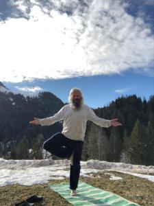 a man is doing a pose on a yoga mat at L'Étoile Enchantée in Ciernes-Picat