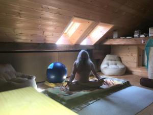 a man sitting on a bed in a room with skylights at L'Étoile Enchantée in Ciernes-Picat