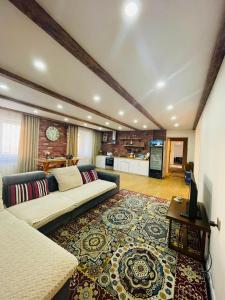 a large living room with a couch and a kitchen at Summit guest house in Ulaanbaatar