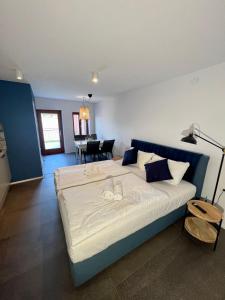 a bedroom with a large bed and a dining room at Libertas apartments in Koper