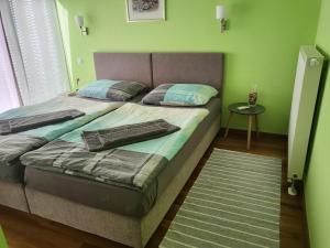 a bedroom with a bed with a green wall at Villa Dambo mit Pool , 4 Sterne in Grkavešćak +63 photos