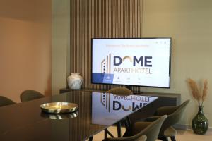 a dining room with a table and a screen at The Dome Aparthotel in Satu Mare