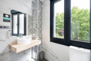 baño con lavabo y ventana en Albergue Alda Pilgrim Ponferrada, en Ponferrada