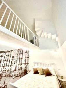 a white bedroom with a bed and a staircase at Granoro Gragnano B&B in Gragnano
