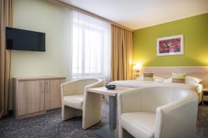Uma televisão e/ou sistema de entretenimento em Hotel Mlynska