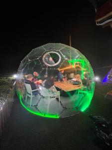 a group of people sitting at a table in an igloo at night at Mosa Bungalov in Ardeşen