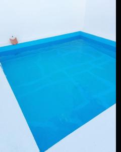 a large swimming pool with blue water in it at Moradia com Piscina Casa Mourisca Alqueva in Mourão