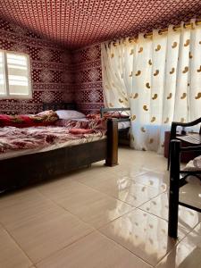 a bedroom with a bed and curtains in a room at Sun rise wadi rum camp in Wadi Rum