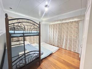a bedroom with a bunk bed and a window at House B Spacious 3BR3TB along Commonwealth Ave in Manila