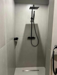 a shower in a bathroom with a shower at Bukovel Village Apartments in Bukovel