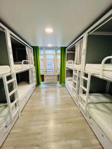 a room with four bunk beds with a wooden floor at Alberguinn in Barcelona