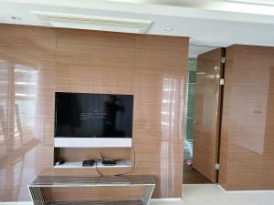 a living room with a flat screen tv on a wall at Seopjikoji Oceanview Apartment in Seogwipo