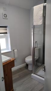 a bathroom with a toilet and a sink at Southwell Stays in Southwell