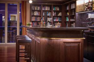 a bar in a library with a book shelf at Das Hotel Eden - Das Aktiv- & Wohlfühlhotel in Tirol auf 1200m Höhe in Seefeld in Tirol +49 photos
