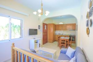 a living room with a couch and a kitchen at Villa Kalithea in Nisaki