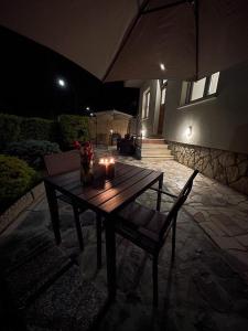 a wooden table with candles on a patio at night at La Mirage in Desenzano del Garda