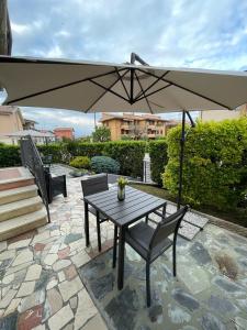 a table and chairs under an umbrella on a patio at La Mirage in Desenzano del Garda