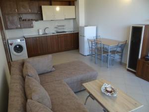 a living room with a couch and a table and a kitchen at Oasis Beach Home Four in Lozenets