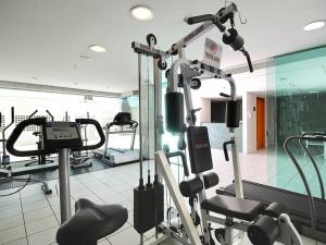 a gym with cardio equipment in a room at Flat Mercure 1km do Planalto Central h07 in Brasilia
