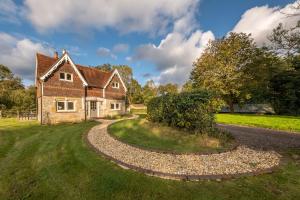 an old brick house with a winding road at Hensill Farmhouse in Hawkhurst