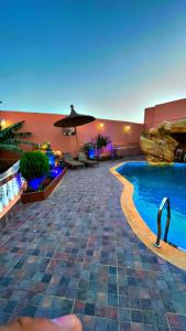 a pool at a resort with a swimming pool at Riad dar salam in Agadir