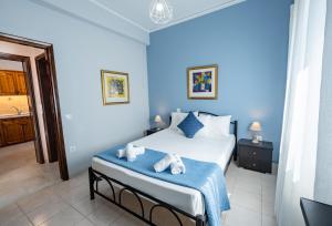 a blue bedroom with a bed with towels on it at La Casa Di Volpe in Corfu
