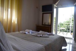a bedroom with a bed with towels on it at Garden House - Kastri Crete in Kastrí
