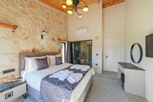 a bedroom with a bed and a mirror at Ader villa 3 in Fethiye