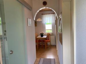 a hallway with a table and a dining room at Ferienhaus Seeblick in Sassnitz