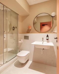 a bathroom with a toilet and a sink and a mirror at Gogaille - Fernand Rabier - accès autonome in Orléans