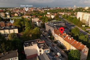 an aerial view of a city with buildings and cars at Apartamenty Stara Warszawska 43 in Olsztyn