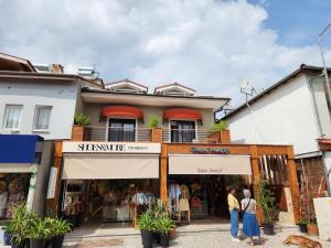 a store front of a building with people standing outside at Guney Suites by Villa Safiya in G&ouml;cek