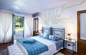 - une chambre dotée d'un lit avec une couverture bleue et blanche dans l'établissement Colto Dei Pallanti, à Cavriglia