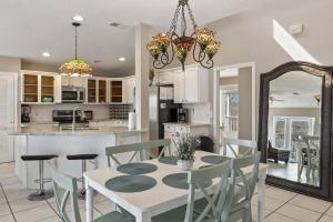 a kitchen and dining room with a table and chairs at Sea Forever Ocean Lookout Flagler Beach Ocean Views Pet Friendly in Flagler Beach