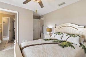 a bedroom with a white bed and a ceiling fan at Sea Forever Ocean Lookout Flagler Beach Ocean Views Pet Friendly in Flagler Beach