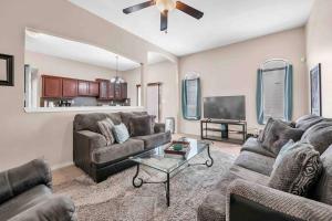 a living room with two couches and a flat screen tv at Comfy Classy Home, Close To Everything in El Paso