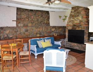 un soggiorno con divano, tavolo e TV di Houdenbek Farm Cottages a Ceres