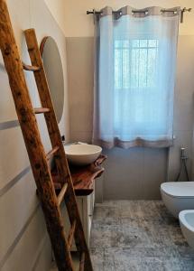 un baño con una escalera junto a un lavabo y un espejo en Picnic Room and Pool en Castelnuovo del Garda