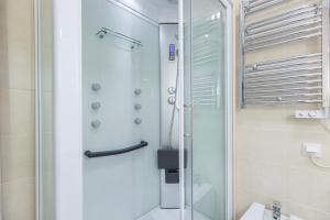 a bathroom with a shower with a glass door at Gia's Homes Cascais by LovelyStay in Cascais