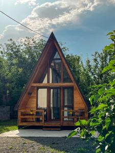 a small cabin with a large window in a forest at Mtskheta Cabin in Mtskheta