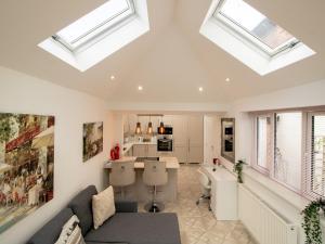 a living room with skylights in the ceiling at Pass the Keys Modern Coastal Cottage in North Shields