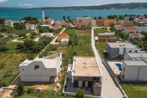 an aerial view of a city with houses and the water at Luxury Villa Bueno in Kaštela +34 photos