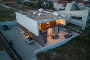 an aerial view of a house with a van on the roof at Luxury Villa Bueno in Kaštela