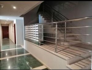 a hallway with metal shelves in a building at Apartamento Piscina 2G by Urraca Suites Viveiro in Viveiro